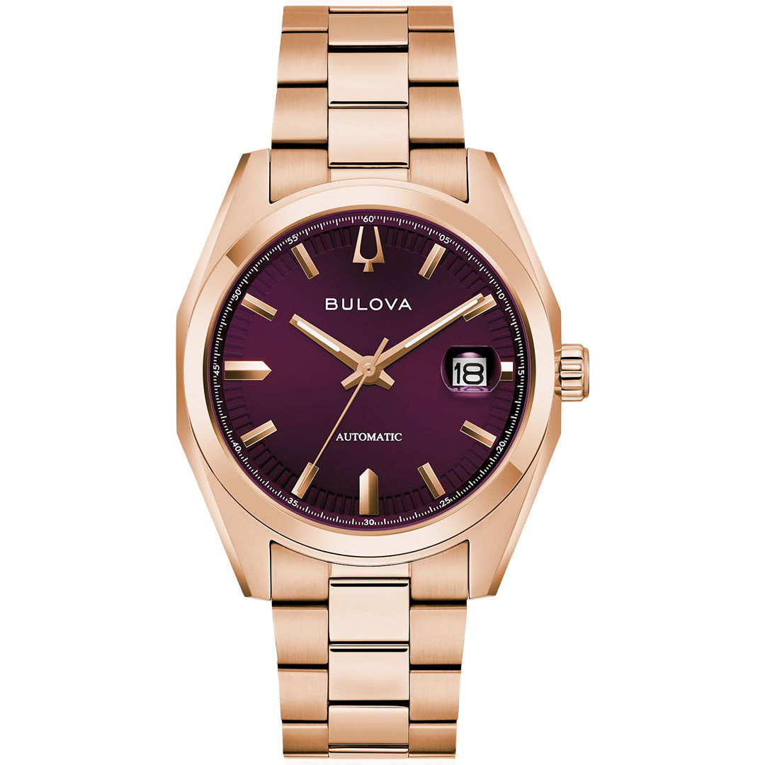 The Bulova Surveyor Automatic 39mm Watch features a rose gold-tone case, metallic bracelet, deep burgundy dial with gold hour markers, and a date window at 3 o’clock.