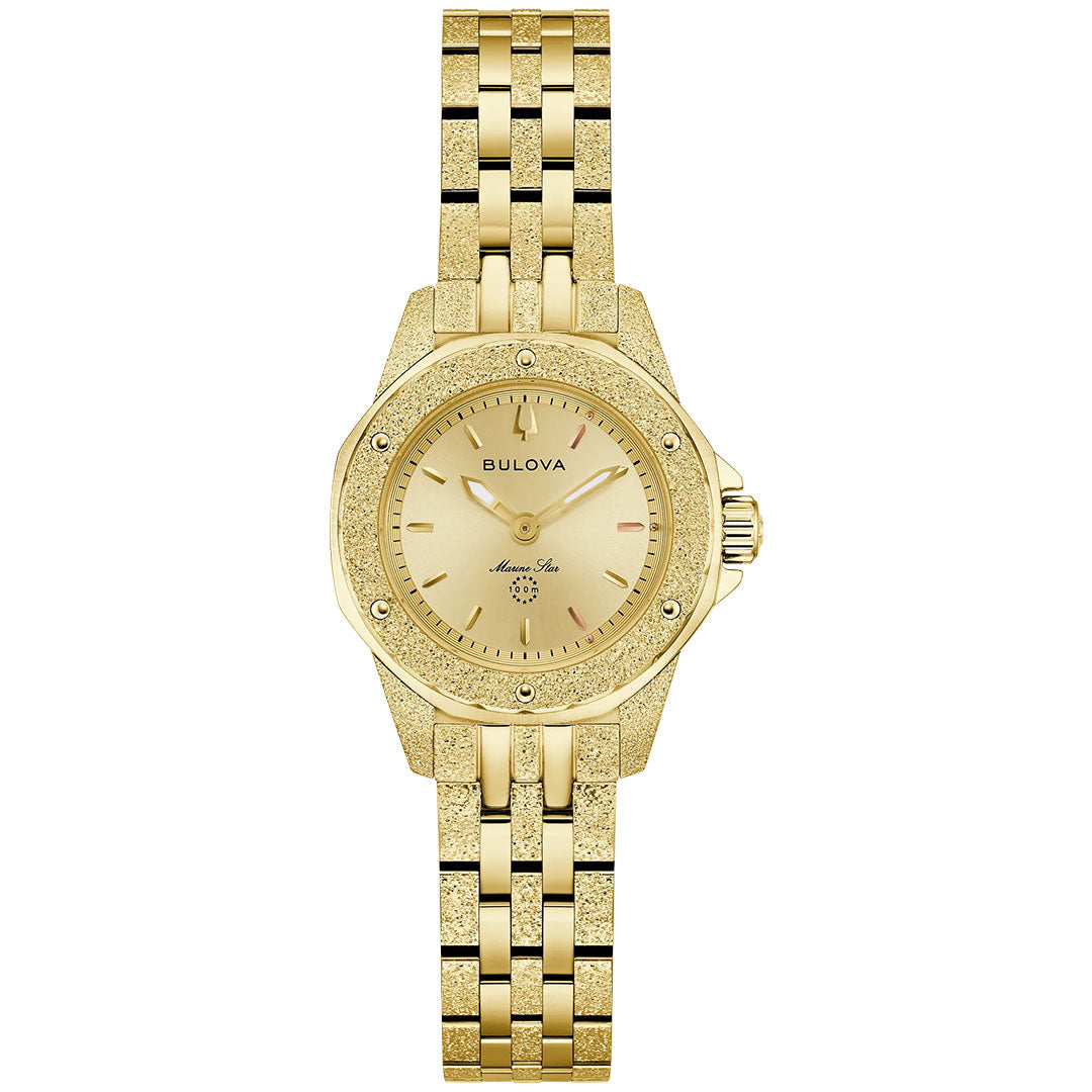 The Bulova Marine Star Marc Anthony Quartz 25.5mm Watch features a gold-tone case, round dial with minimal hour markers, linked metal band, and displays the Bulova logo for a simple, elegant look without number markers.