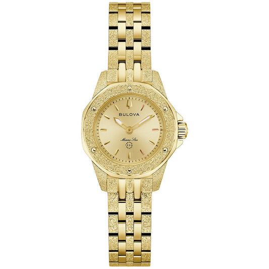 The Bulova Marine Star Marc Anthony Quartz 25.5mm Watch features a gold-tone case, round dial with minimal hour markers, linked metal band, and displays the Bulova logo for a simple, elegant look without number markers.