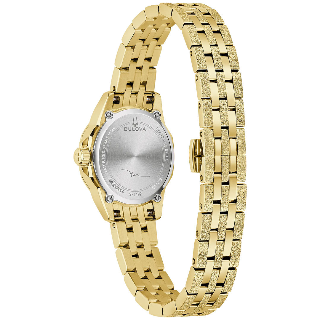 The Bulova Marine Star Marc Anthony Quartz 25.5mm Watch features a gold-tone stainless steel link bracelet and a round silver case back with engraved details, shown here from the back.