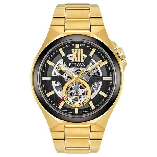 The Bulova Maquina Automatic 46mm Watch by Bulova boasts a skeleton automatic movement and sapphire glass. Featuring a skeleton dial that reveals the intricate internal mechanics, it includes gold hour markers and a Roman numeral XII at the top. The watch is complemented by a gold-tone stainless steel bracelet, enhancing its elegant design.