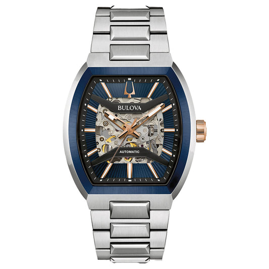 The Bulova Maquina Automatic 40mm Watch features a silver metal band, blue and silver tonneau-shaped case, partially open skeleton dial with rose gold accents, and exposed internal gears.