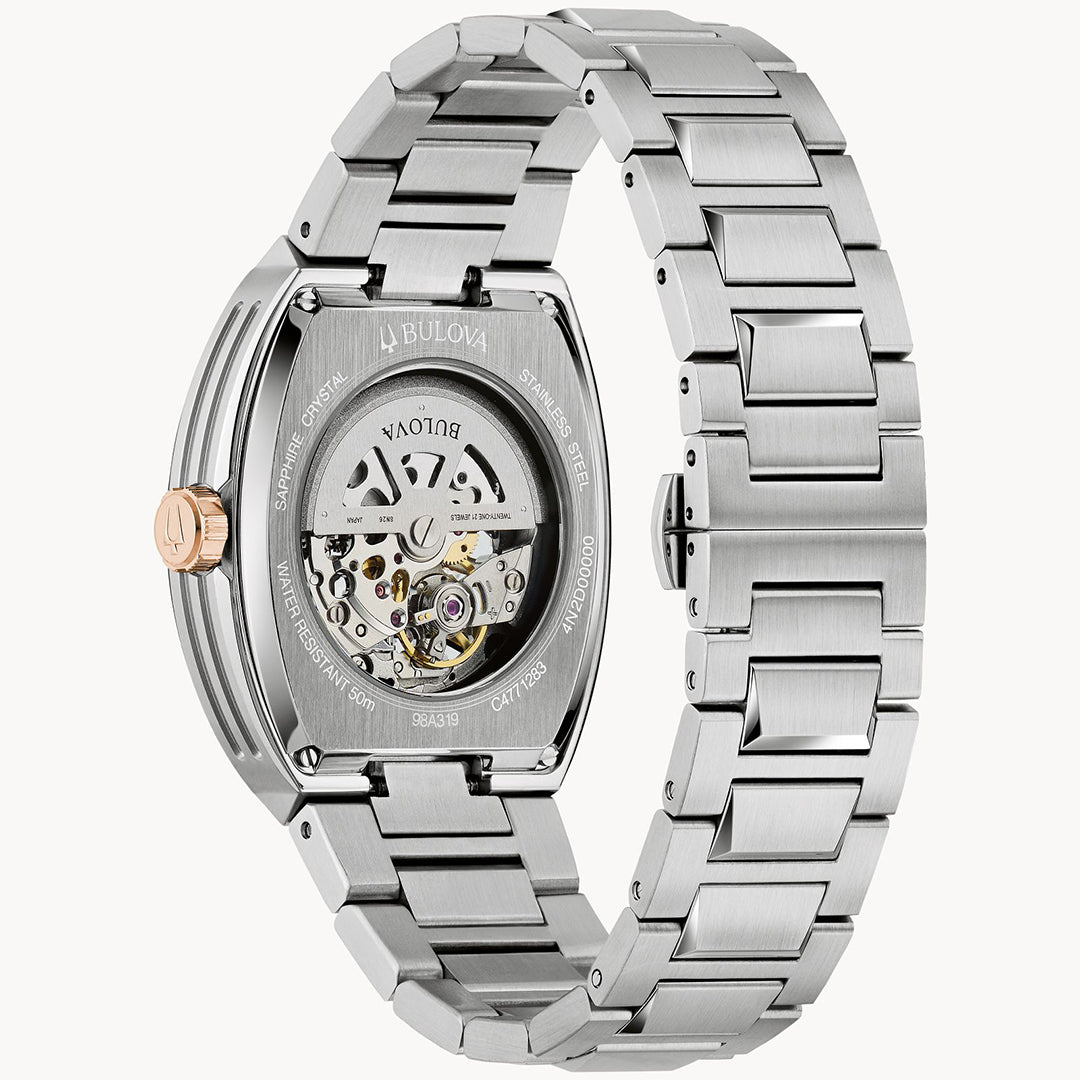 The Bulova Maquina Automatic 40mm Watch features a stainless steel caseback with a transparent window showing its mechanical movement, a metal link bracelet, and a rose gold-tone crown.