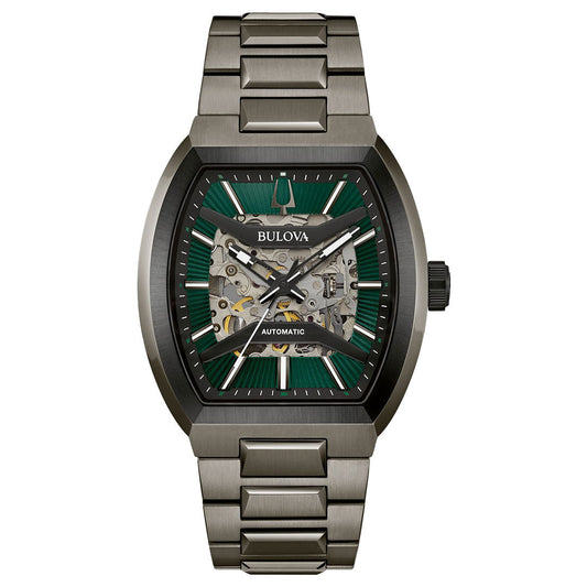 The Bulova Maquina Automatic 40mm men's watch features a metallic band, green and black rectangular dial with silver markers, and a partially open skeleton design showcasing its intricate inner mechanisms.