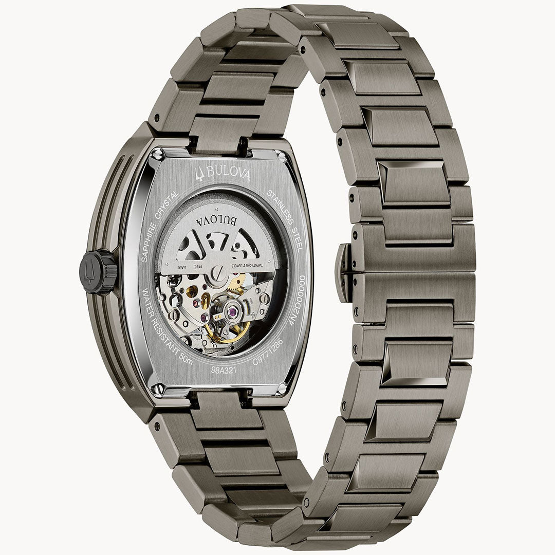 The Bulova Maquina Automatic 40mm Watch is shown from the back, displaying its automatic movement through a transparent case back and featuring a brushed stainless steel link bracelet.