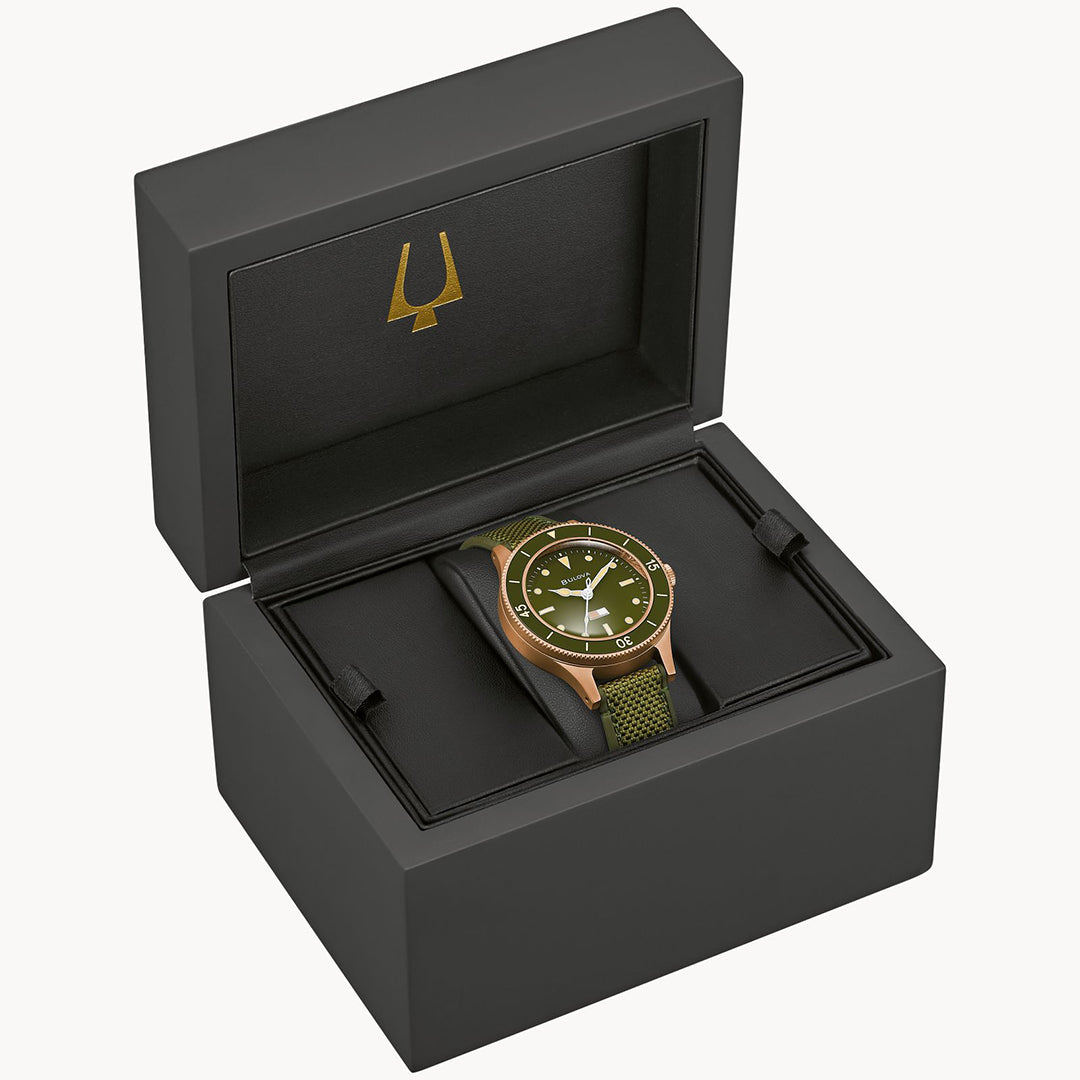 In celebration of Bulova’s 150th Anniversary, the Bulova Mil Ships Automatic 41mm Watch is presented in a black box, featuring a green dial and strap with gold accents inspired by the U.S. Navy's precision, paying tribute to the iconic MIL-SHIPS Bronze collection.