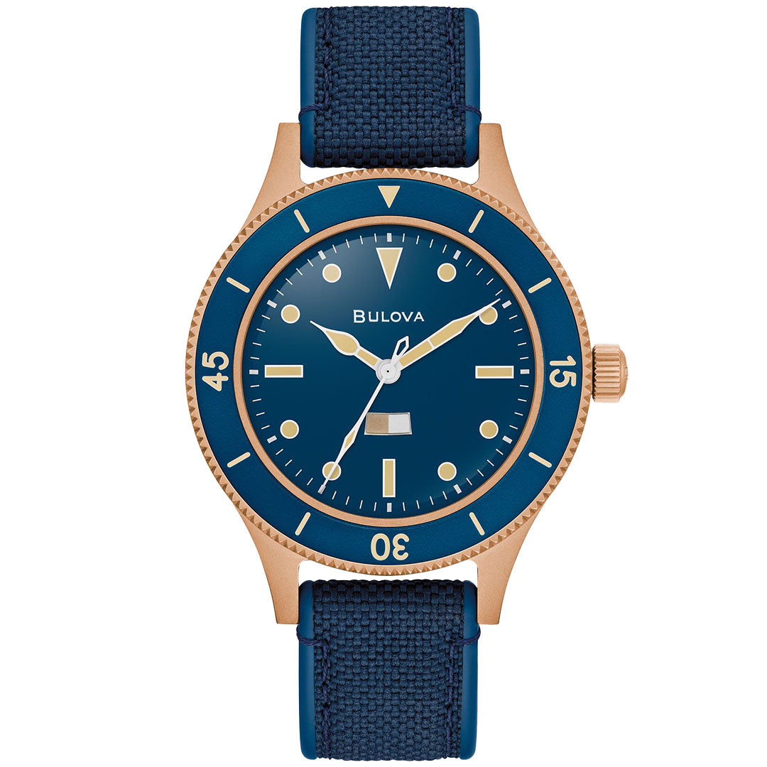 The Bulova MIL Ships CUSN8 Bronze Archive Series Automatic 41mm Watch features a blue fabric strap, blue dial, gold-tone bronze case, simple hour markers, and a minimalistic three-hand design for a sleek appearance.