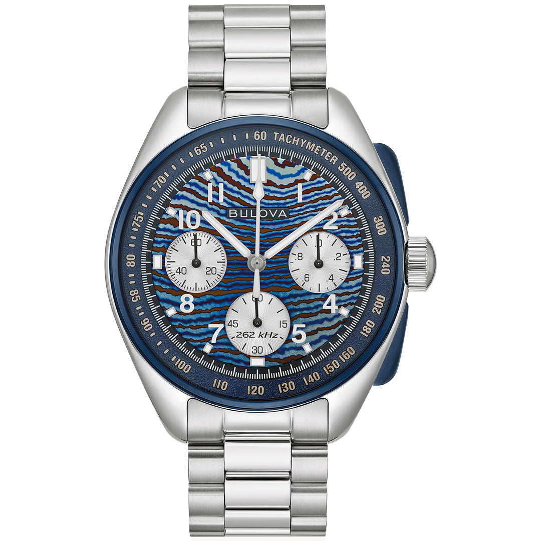 The Bulova Lunar Pilot Timascus Quartz 43.5mm Watch is a limited edition of 5,500 pieces, featuring a blue patterned dial with three subdials, white hour markers, tachymeter bezel, quartz movement, and a sleek silver metal link bracelet.