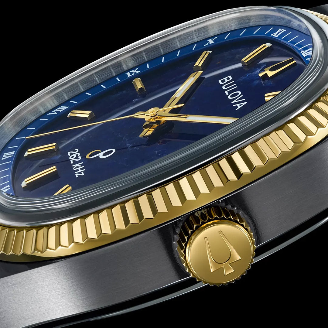 Close-up of a Bulova Super Seville HPQ Precisionist Quartz 35mm men's luxury watch featuring a blue dial, gold hands and markers, a gold crown, and a ridged gold bezel on a silver case. The dial displays "262 kHz," emphasizing its high-precision Precisionist movement.