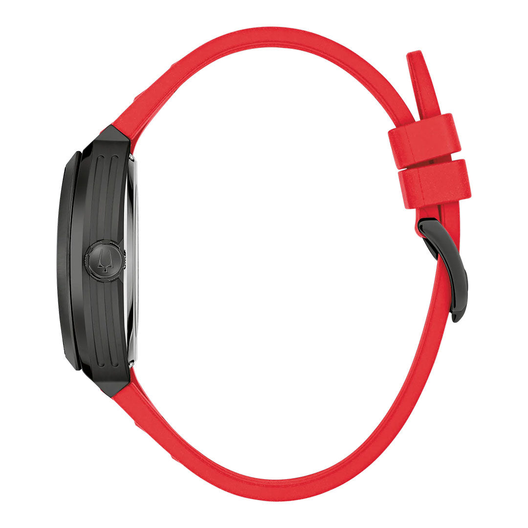 The Bulova Maquina Automatic 40mm Watch is shown from the side, featuring a black case from the Maquina collection, a red silicon strap with two loops and a black buckle, and a visible watch crown—highlighting this striking men’s timepiece by Bulova.