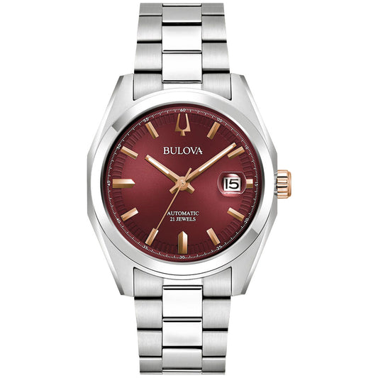 The Bulova Surveyor Automatic 39mm Watch by Bulova presents an elegant maroon dial adorned with gold hour markers and hands, paired with a durable stainless steel bracelet. It includes a date window at the 3 o'clock position and prominently features "Automatic 21 Jewels.