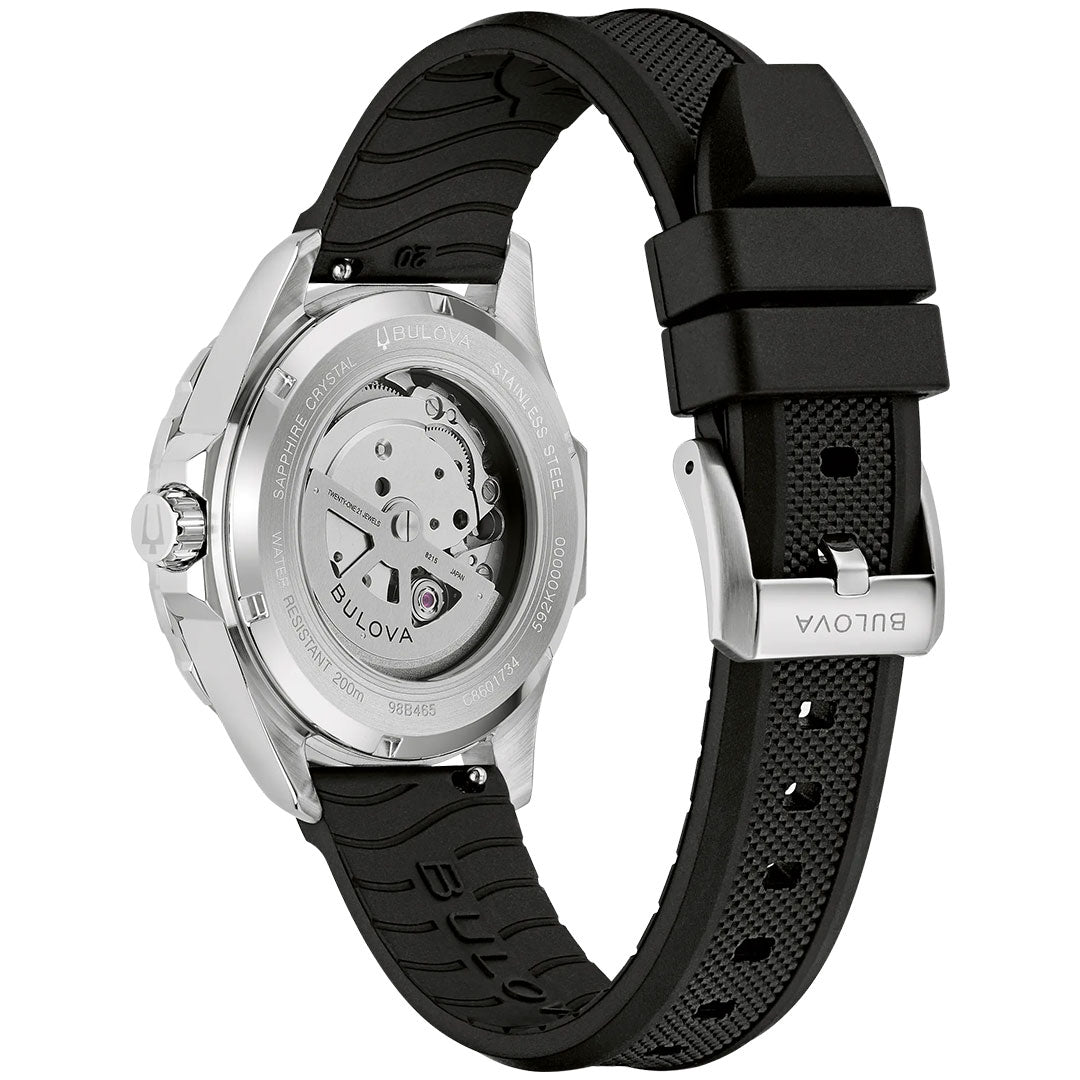 A close-up of the Bulova Marine Star Series B Automatic 41mm watch showcases its stainless steel case, exposed automatic movement, and black textured rubber strap with a buckle clasp engraved with the Bulova logo.