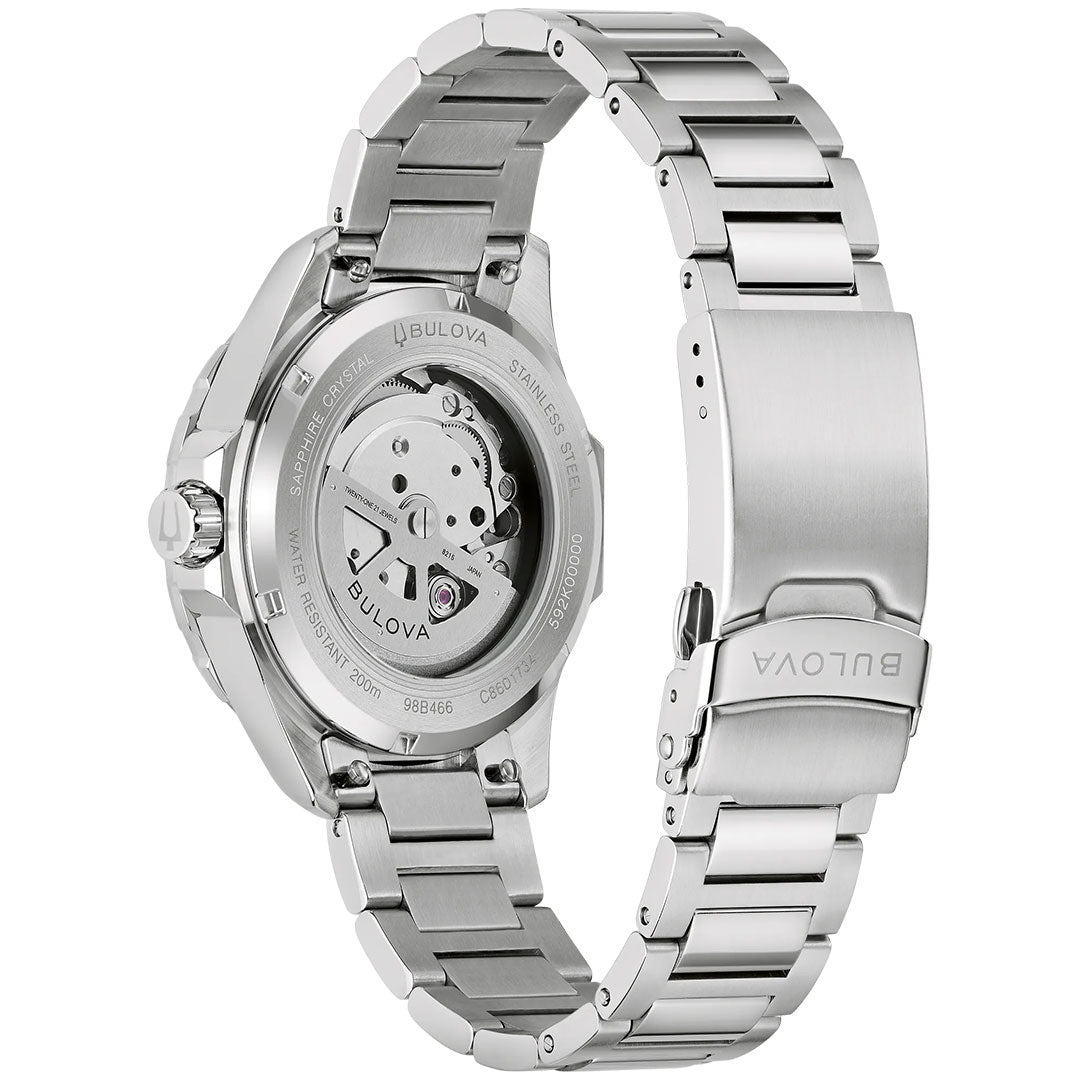A close-up of the Bulova Marine Star Series B Automatic 41mm watch, made of stainless steel, shows its open bracelet, transparent case back with visible automatic movement, and the engraved Bulova logo on the clasp.