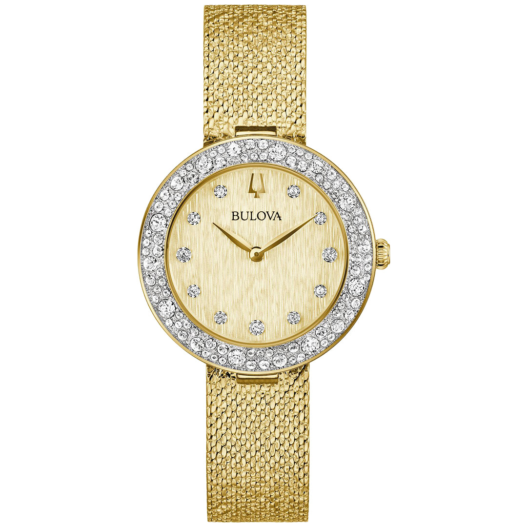 The Bulova Crystal Quartz 32mm Watch is a gold wristwatch with a textured band and an Austrian crystal-embellished bezel. It features a champagne dial with small crystal hour markers, offering both elegance and timeless appeal.