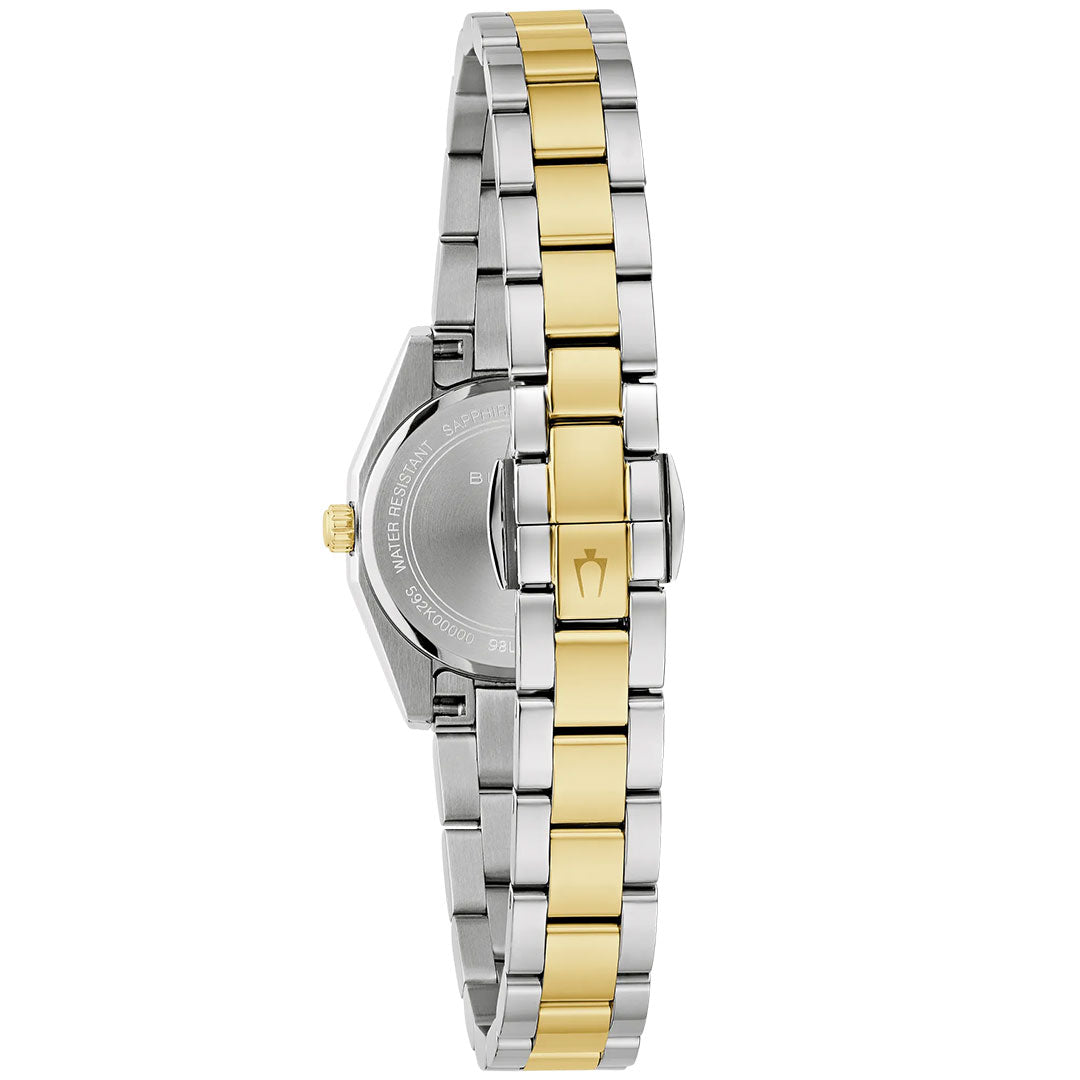 A close-up of the back of a Bulova Surveyor Quartz 22.7mm ladies’ watch shows its round silver case and metal band with alternating silver and gold links, plus a closed clasp. The timepiece is by Bulova.