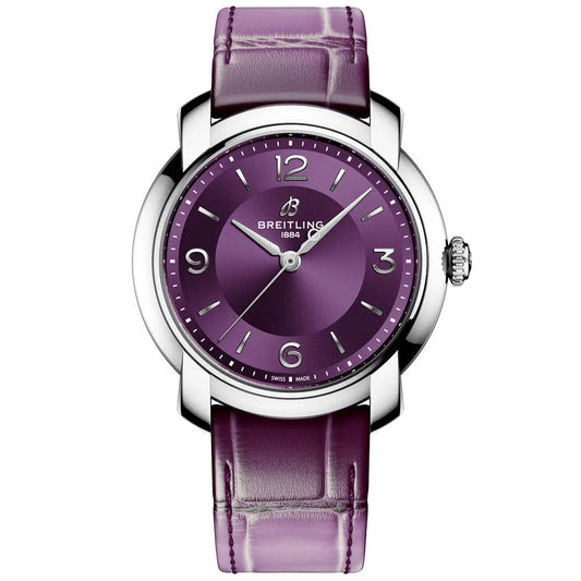 The BREITLING Lady Premier Automatic 36 is a stylish women’s chronograph with a purple dial, silver hour markers, and a matching purple leather strap in a polished silver case.