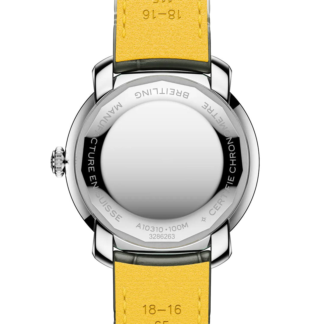 The back of a BREITLING Lady Premier Automatic 36 women’s watch by Breitling features a yellow leather strap, silver case, and engravings such as "BREITLING" and "CERTIFIE CHRONOMETRE." The watch face is not visible.