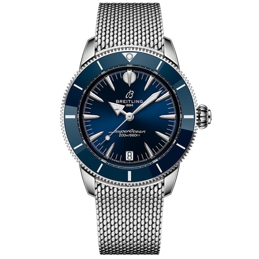 The BREITLING Superocean Heritage B31 Automatic 36 features a blue dial, ceramic bezel, silver hour markers, and a stainless steel mesh bracelet, shown here displaying the time 10:08.