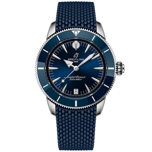 The BREITLING Superocean Heritage B31 Automatic 36 features a blue textured strap, polished silver case, ceramic bezel, blue dial with silver hands and markers, plus white text displaying the Breitling brand and model.