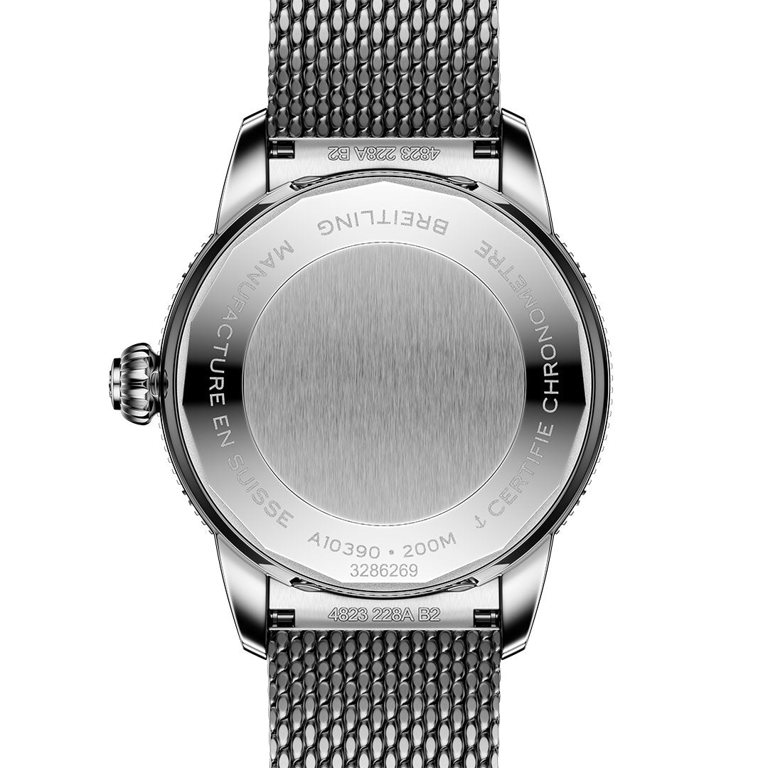 The back of the BREITLING Superocean Heritage B31 Automatic 36 features a stainless steel mesh strap and engraved details like brand, model, water resistance (200M), and “Manufacture en Suisse.”.