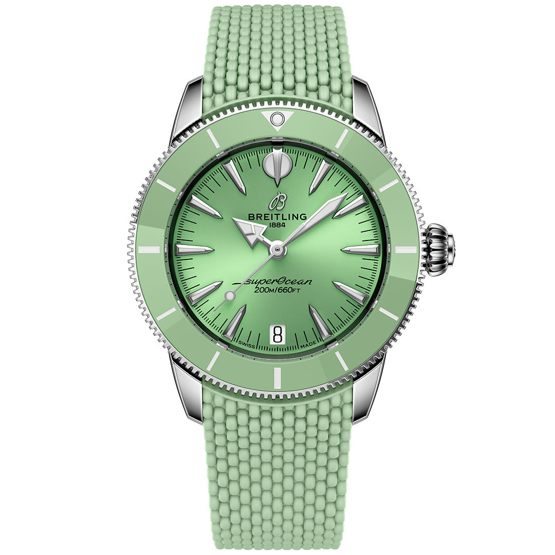 The BREITLING Superocean Heritage B31 Automatic 36 is a mint green dive watch with a ceramic bezel, textured rubber strap, silver markers and hands, stainless steel case, date at 6 o’clock, and "1884" plus "200M/660FT" on the dial.