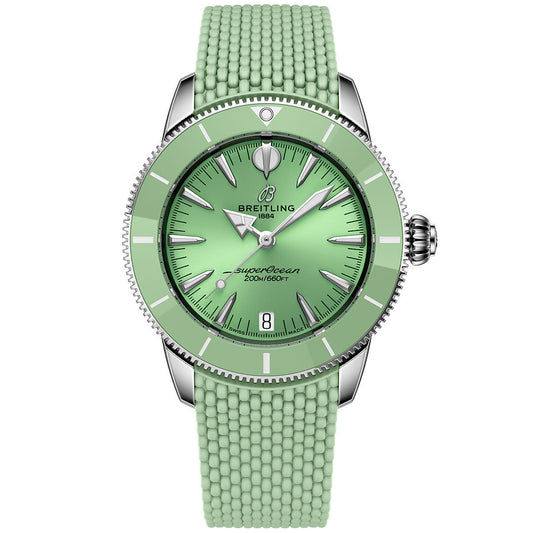 The BREITLING Superocean Heritage B31 Automatic 36 is a mint green dive watch with a ceramic bezel, textured rubber strap, silver markers and hands, stainless steel case, date at 6 o’clock, and "1884" plus "200M/660FT" on the dial.