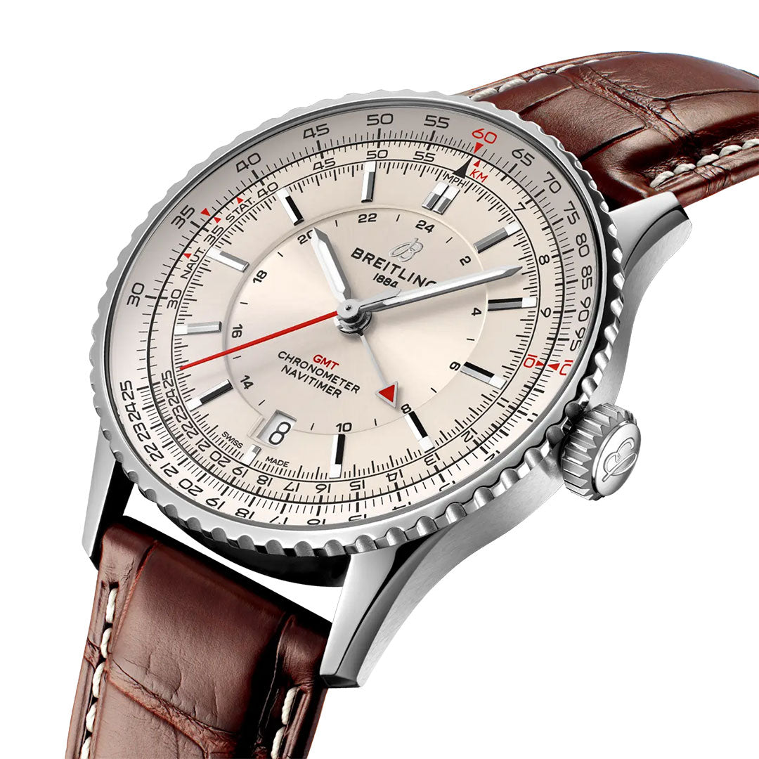 A close-up of the Breitling Navitimer Automatic GMT 41, featuring a brown leather strap, silver dial with multiple scales, and black and red markers, highlighting its intricate chronometer details.