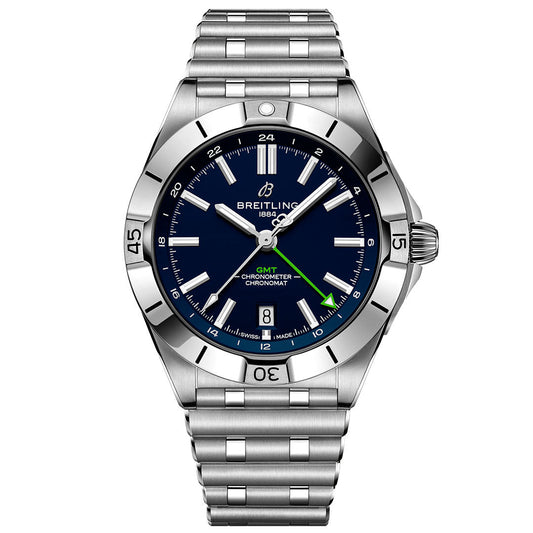 The BREITLING Chronomat Automatic GMT 40 features a stainless steel case, blue dial, silver markers and hands, a green GMT hand, date at 6 o’clock, link bracelet, and a bezel with engraved numerals and markers.