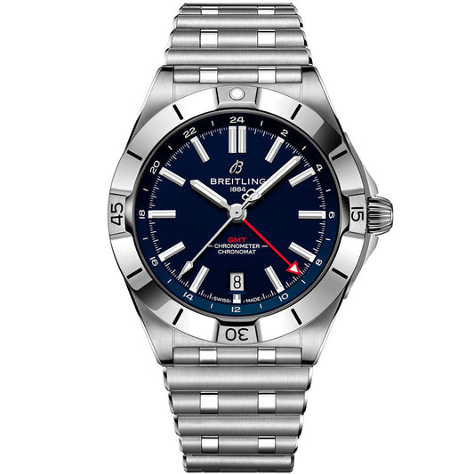 The Breitling Chronomat Automatic GMT 40 is a stainless steel wristwatch with a blue dial, silver hour markers, red GMT hand, date at 6 o’clock, and metal link bracelet. Its sporty bezel has engraved numbers for a dynamic look.