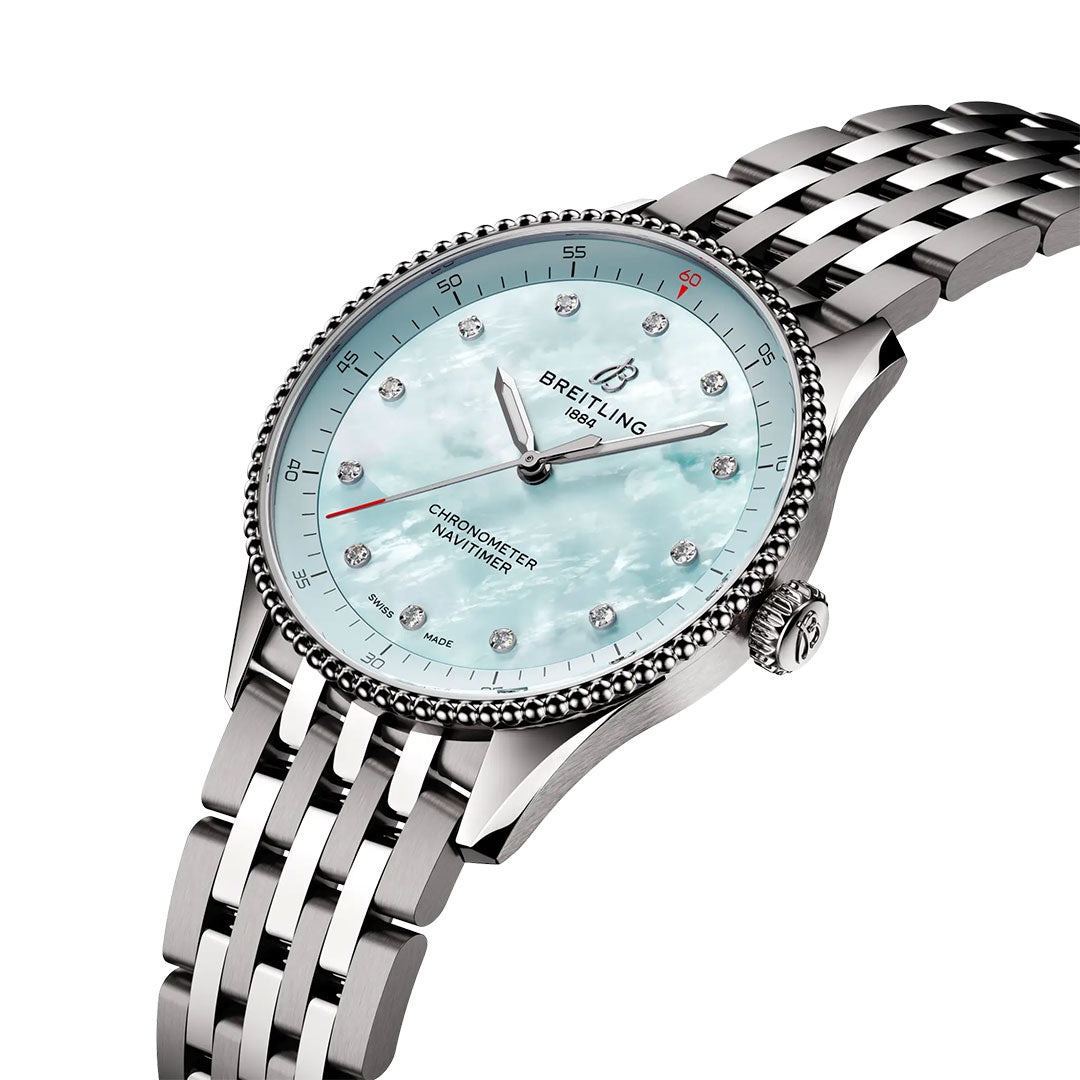 The BREITLING Navitimer 32 luxury watch by Breitling features a silver metal bracelet, light blue mother-of-pearl dial with diamond hour markers, and a beaded bezel, displayed at an angle on a white background.