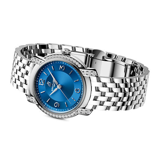 The BREITLING Lady Premier 32 women's watch by Breitling features a blue face with silver hour markers, diamond-accented bezel, and a polished metal link band, shown at an angle for timeless elegance.