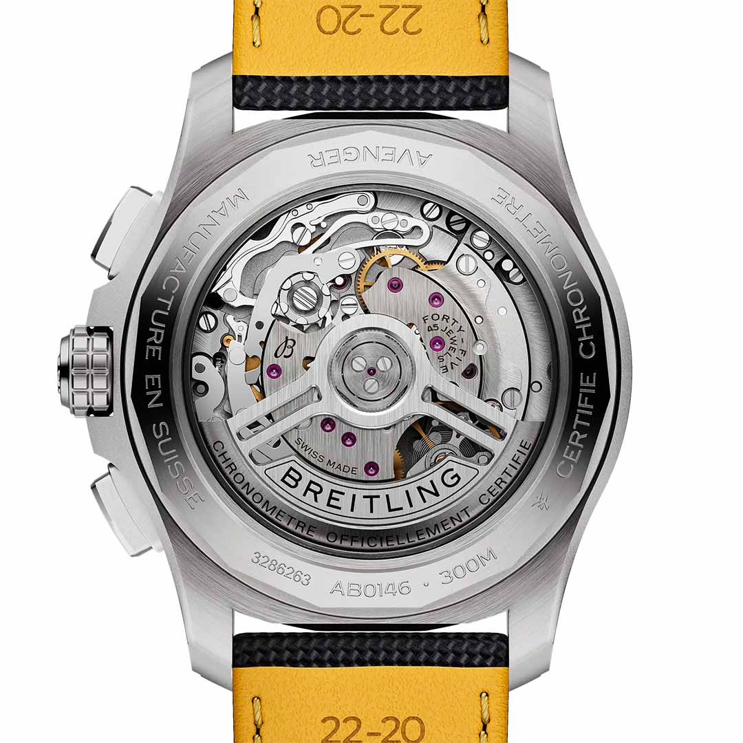 Close-up of the back of the BREITLING Avenger B01 Chronograph 42, highlighting its intricate mechanical movement and gears. The transparent case displays details like "Manufacture en Suisse" and "Chronometre Certifie," with an aviation-style yellow and black strap partially visible, reflecting the precision admired by jet pilots.