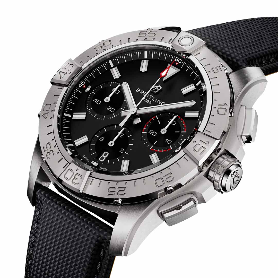 The BREITLING Avenger B01 Chronograph 42 by Breitling features a sleek, aviation-style textured strap in silver and black. This watch offers a black dial with silver markers and multiple sub-dials, all housed within a polished metal case. The bezel is adorned with engraved numbers reminiscent of those found on jet pilot instruments.