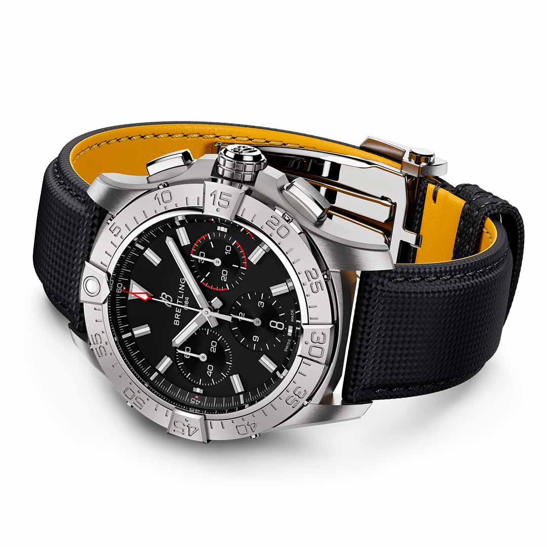 The BREITLING Avenger B01 Chronograph 42 by Breitling is a luxury watch that exudes aviation style with its black dial, silver bezel, and three sub-dials. It features a black leather strap with yellow lining, reminiscent of jet pilots' gear, and a silver clasp. The watch displays white hour markers and hands, along with a date function near the 3 o'clock position.