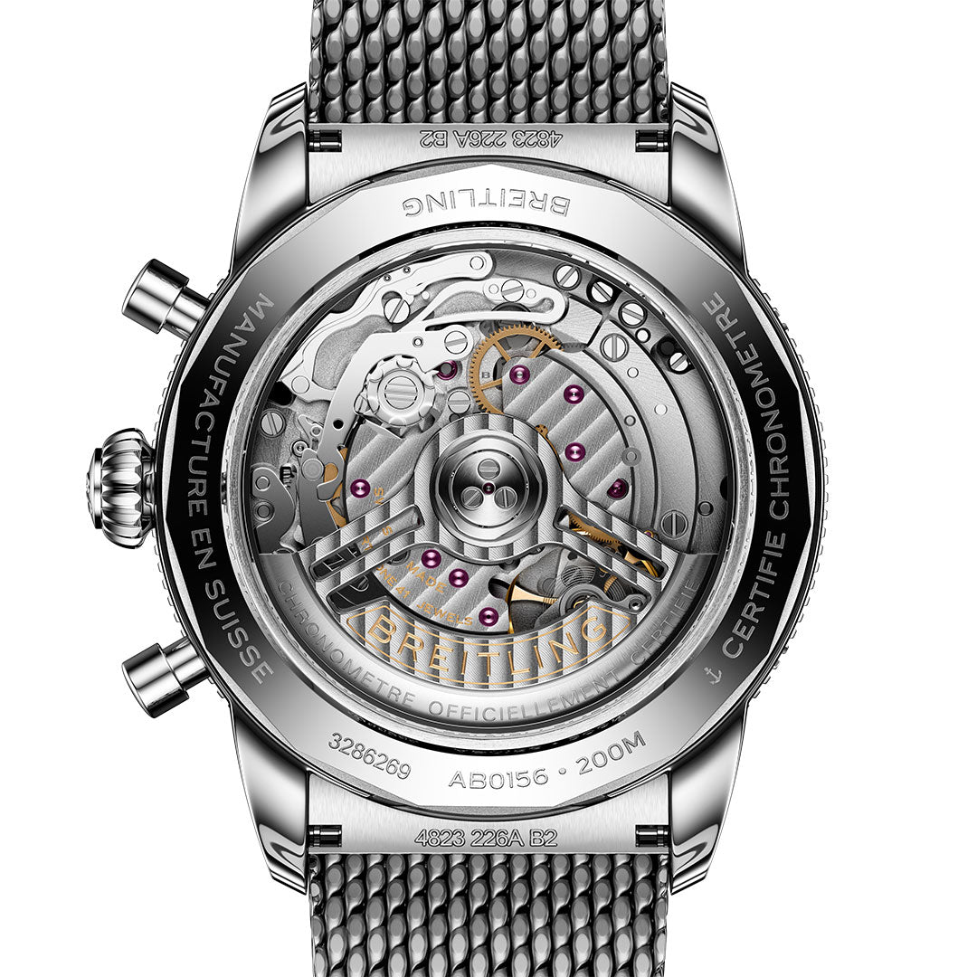 Close-up of the BREITLING Superocean Heritage B01 Chronograph 42’s back, displaying its Breitling Manufacture Caliber 01 movement through a transparent case back, with visible gears and engraved details.