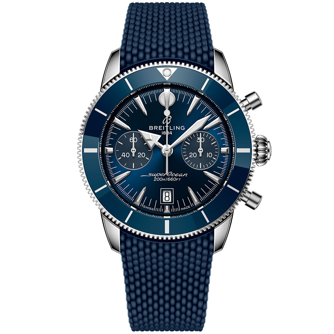 The Breitling Superocean Heritage B01 Chronograph 42 features a blue dial with three subdials, a date window, silver indices, a textured blue rubber strap, and a ceramic bezel with silver edging.
