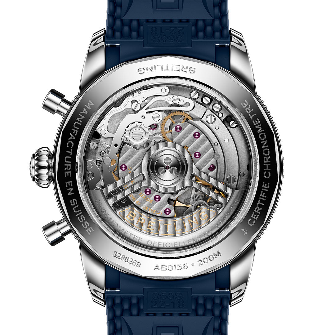 The image shows the back of the BREITLING Superocean Heritage B01 Chronograph 42, displaying its detailed mechanical movement through a transparent case. A blue strap and ceramic rotating bezel enhance this Breitling watch's sophisticated look.
