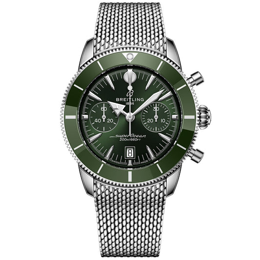 The BREITLING Superocean Heritage B01 Chronograph 42 features a green bezel and dial, silver hour markers, three subdials, a date window at 6 o’clock, and a silver mesh stainless steel strap. Powered by the Breitling Manufacture Caliber 01.