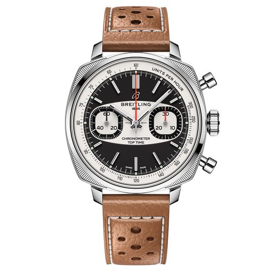 The BREITLING Top Time B01 Racing watch features a modern-retro look with a black and white chronometer dial, two subdials, and a tachymeter scale. It has a brown perforated leather strap, stainless steel case, crown, and two pushers.