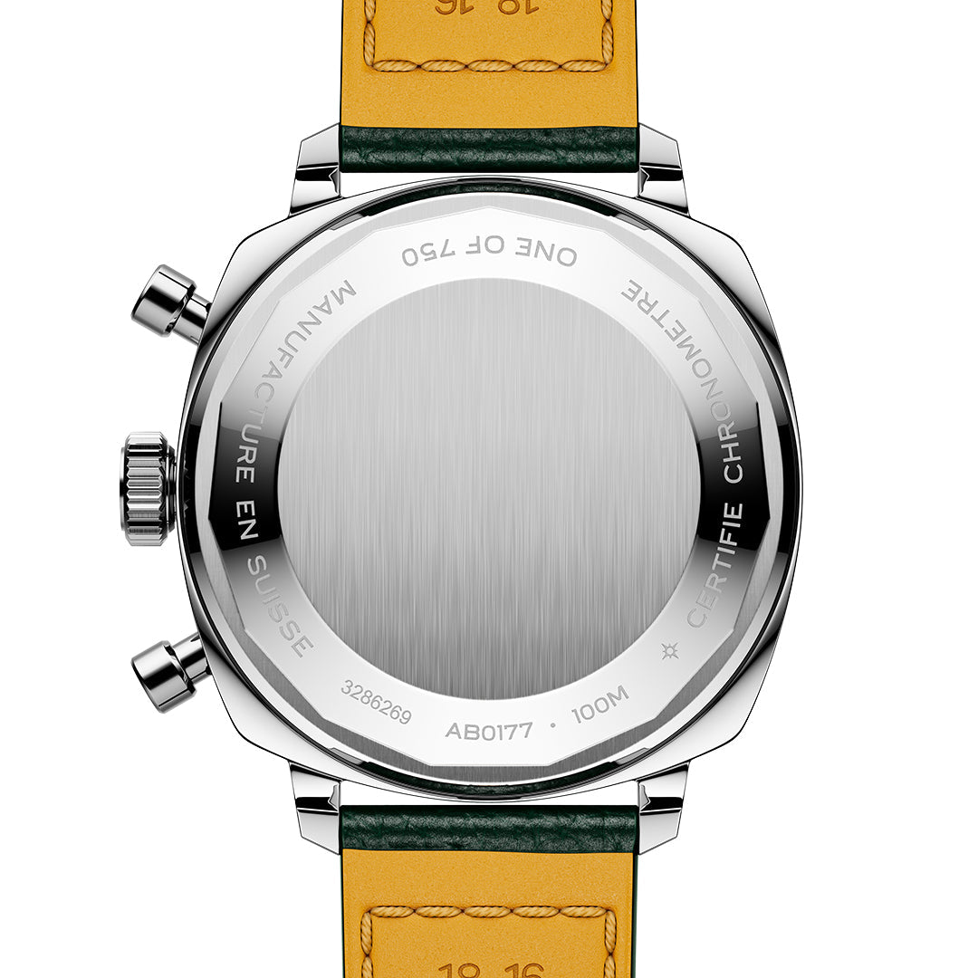 The image shows the back of the BREITLING Top Time B01 Racing watch by Breitling, featuring a silver case with intricate engravings and a yellow-brown leather strap. Marked “Manufacture en Suisse” and “One of 750,” this modern-retro piece hints at classic Top Time Racing allure.