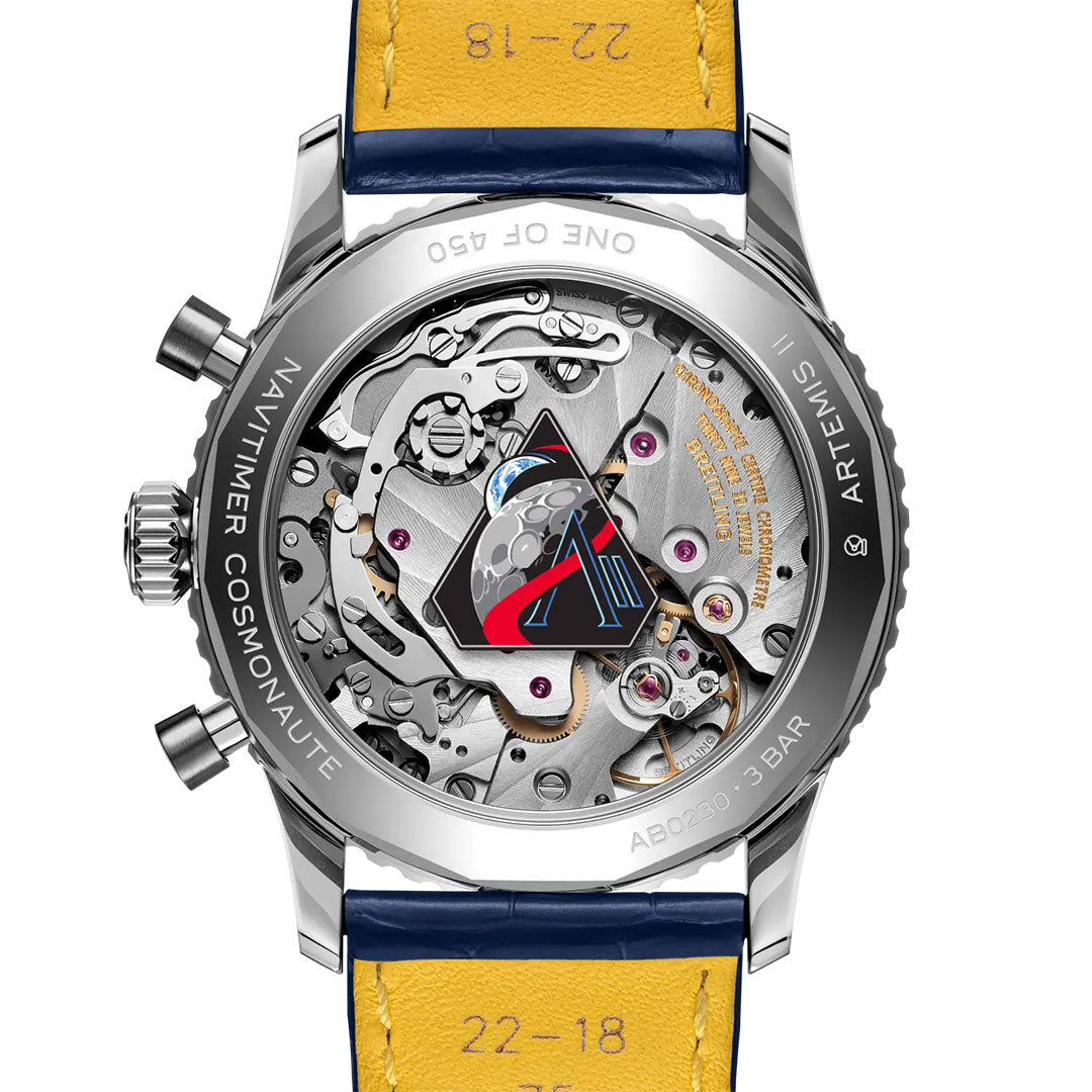 The back of the Breitling Navitimer B02 Chronograph 41 Cosmonaute Artemis II reveals its mechanical movement, blue details, yellow leather strap, and engravings like "ARTEMIS," "ONE OF 450," celebrating the Navitimer Cosmonaute spirit.