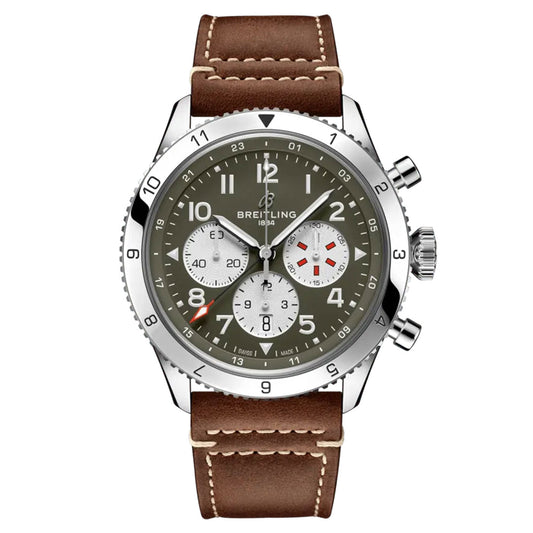 The BREITLING Super AVI B04 Chronograph GMT 46 Curtiss Warhawk celebrates aviation history with its brown leather strap and green dial. It includes three silver subdials, a date window, and Arabic numerals, inspired by the Curtiss P-40 Warhawk. The watch is accentuated by a silver bezel and two side pushers.