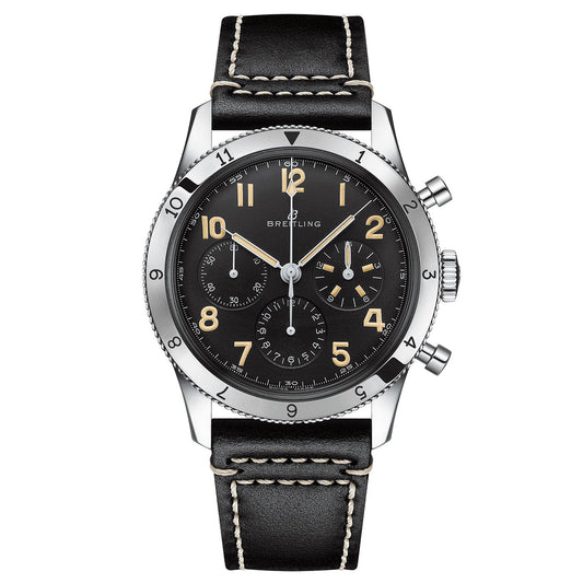 A luxury Certified Pre-Owned BREITLING AVI Ref. 765 1953 Re-Edition wristwatch features a black leather strap with white stitching. This classic pilot's watch showcases a black dial, silver bezel, luminous Arabic numerals, three subdials, and two pushers on the right side. The Breitling brand name is prominently displayed on the face.