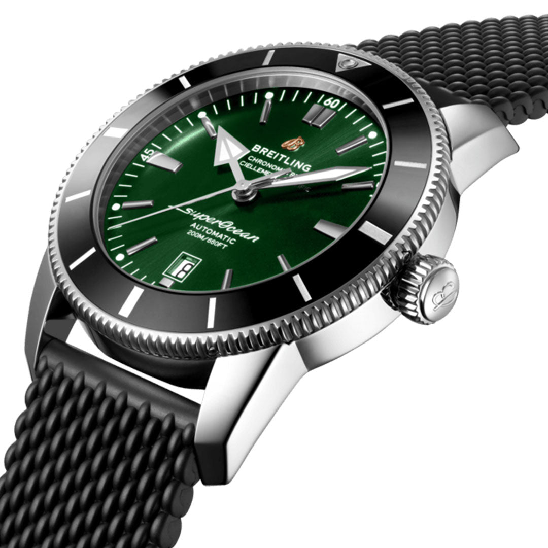 The BREITLING Superocean Heritage B20 Automatic 46 is a luxury diver's watch that features an elegant green dial and silver casing, complemented by white hour markers and a date window. Its black textured strap is set within a polished silver metal frame, while the embossed logo on the crown adds a touch of refinement. This timepiece is powered by the Breitling Manufacture Caliber B20 movement.