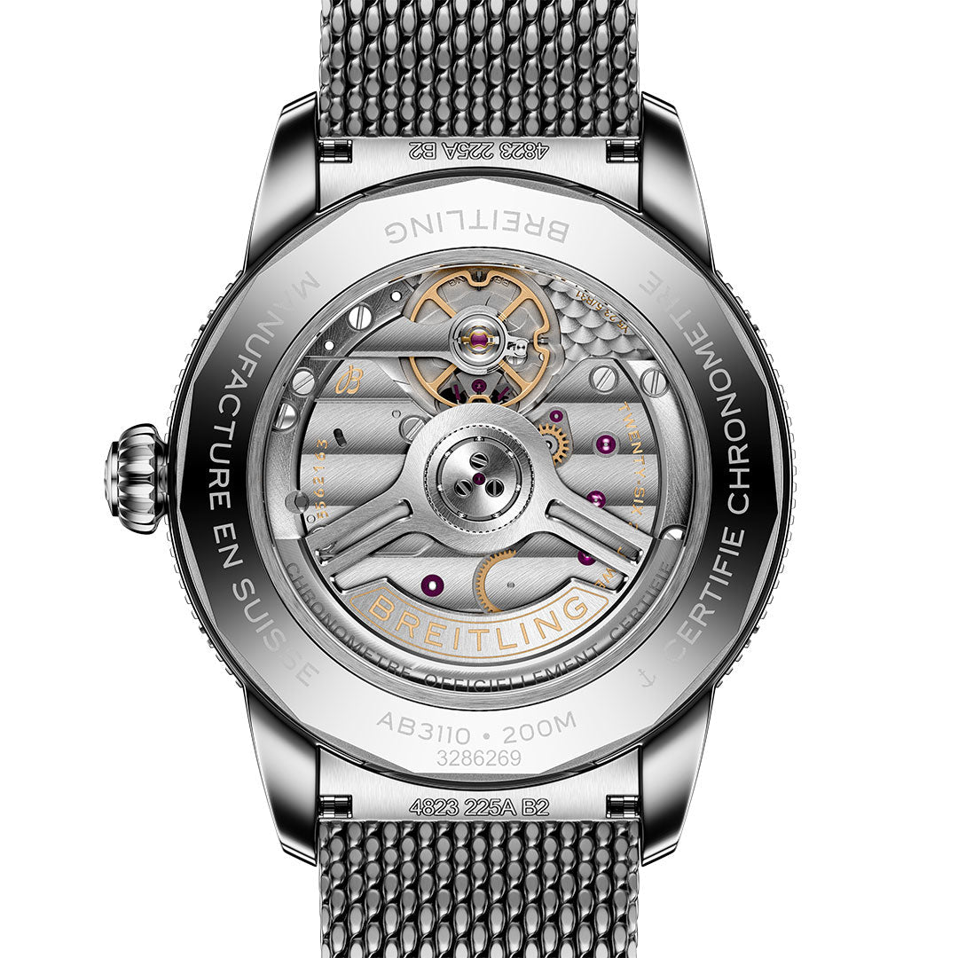 Close-up of the BREITLING Superocean Heritage B31 Automatic 40 by Breitling, showing its mechanical movement and inner gears through a transparent case back, with the metal case and engraved details visible around the edges.