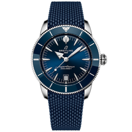 The BREITLING Superocean Heritage B31 Automatic 42 features a deep blue textured strap, blue bezel and dial, silver hour markers, a date display at 6 o’clock, and the Breitling logo at 12—a classic dive watch.