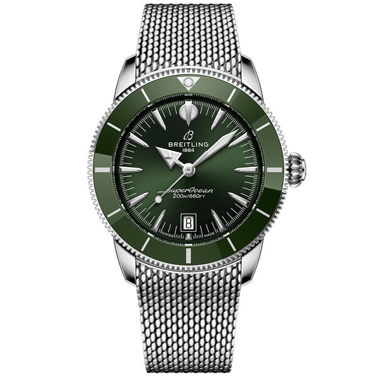 The Breitling Superocean Heritage B31 Automatic 42 features a green bezel and dial, silver hour markers and hands, date window at 6 o'clock, and a stainless steel mesh bracelet with automatic movement.