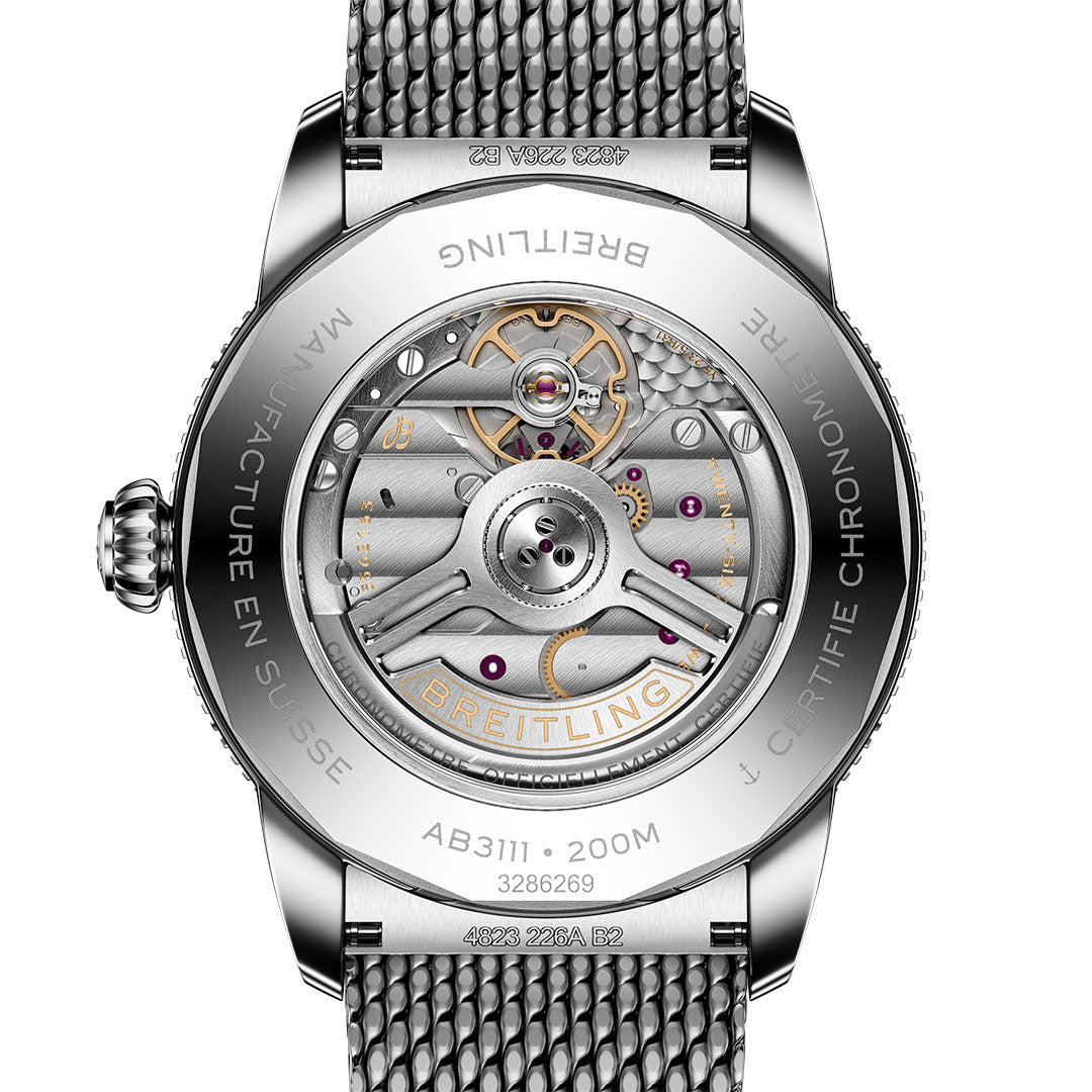 Close-up of the Breitling Superocean Heritage B31 Automatic 42’s back, revealing its automatic movement through a transparent case back, as well as engraved metal details and its distinctive mesh strap.