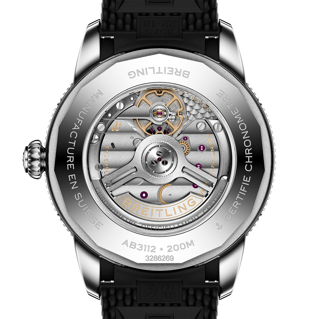 The caseback of the BREITLING Superocean Heritage B31 Automatic 44 displays its detailed automatic movement, visible gears, and engraved markings such as "MANUFACTURE EN SUISSE," "CERTIFIE CHRONOMETRE," and water resistance specs.