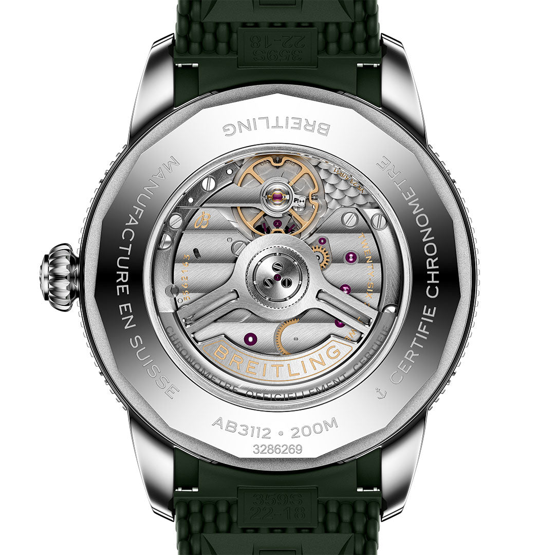 Close-up of the BREITLING Superocean Heritage B31 Automatic 44's caseback, displaying its detailed automatic movement with visible gears, “Manufacture en Suisse,” “Certifie Chronometre” markings, and an engraved rotor.